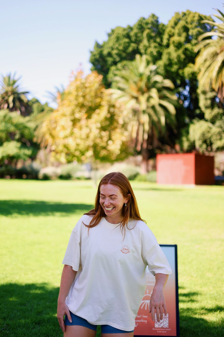 Mish, founder of Newbie Nation, laughing in a park