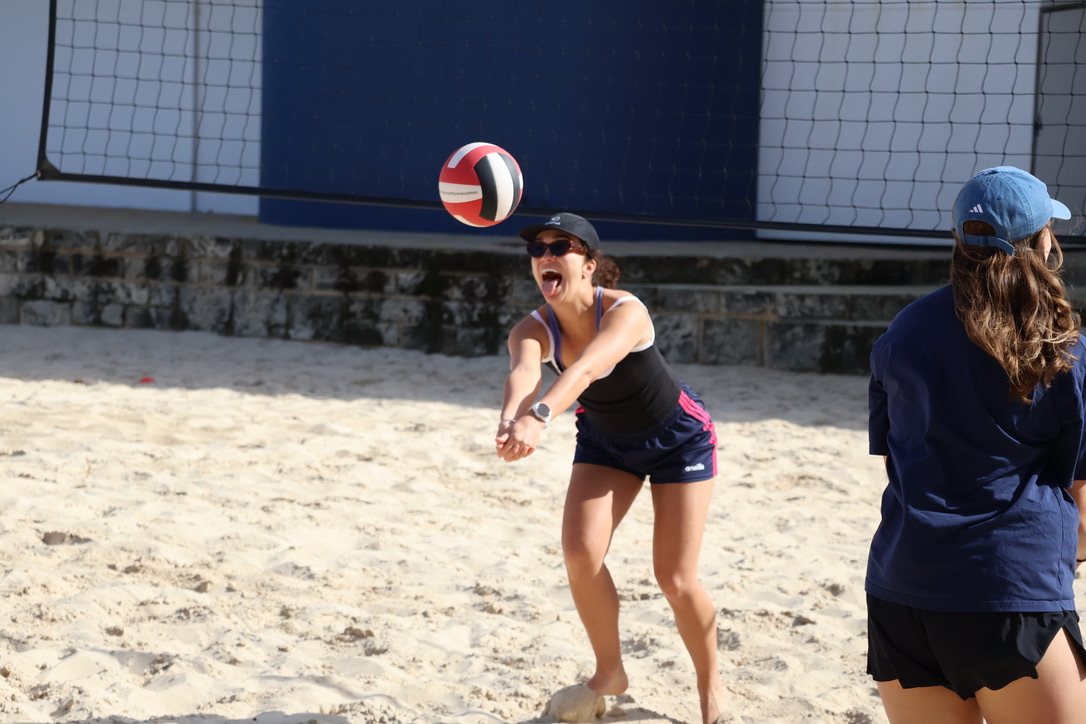 A newbie digging the ball at a beach volleyball social