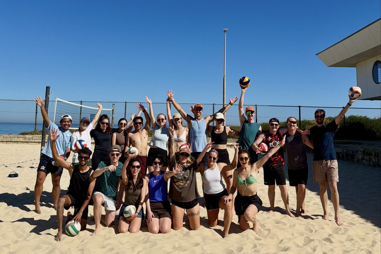 Beach volleyball social group cheering on the sand